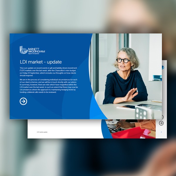 A woman with glasses sits at a desk, looking thoughtfully at a laptop screen. The surrounding environment includes office furniture and a blue presentation slide about the LDI market update. Text details recent investment events.