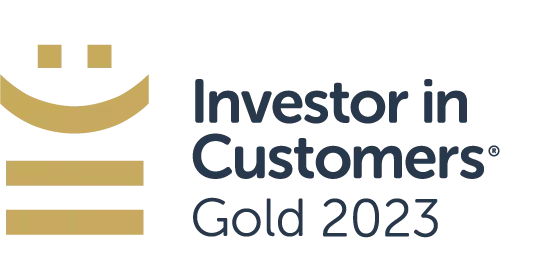 A logo features a stylized gold smiley face above the text “Investor in Customers® Gold 2023,” indicating recognition or achievement in customer investment for the year 2023.