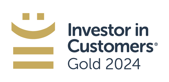 A logo features a smiling face above lines representing growth. It states "Investor in Customers® Gold 2024," indicating recognition in customer investment excellence within a professional context.