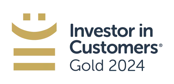A logo features a smiling face above lines representing growth. It states "Investor in Customers® Gold 2024," indicating recognition in customer investment excellence within a professional context.