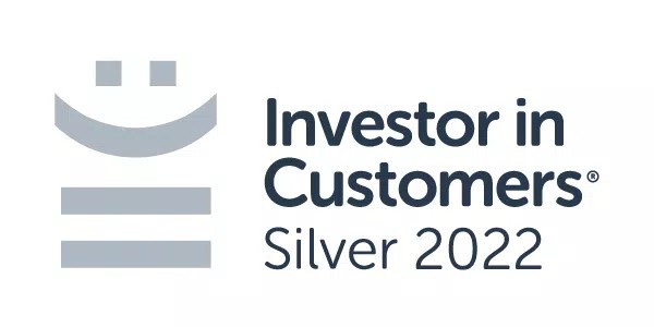 A logo features a stylized smile above three horizontal bars with the text "Investor in Customers® Silver 2022" beside it. The design suggests a focus on customer satisfaction.