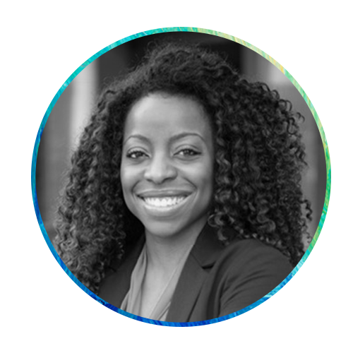 A woman with curly hair smiles confidently, wearing a blazer. She is centered within a circular frame, surrounded by a colorful, abstract blue and green background.