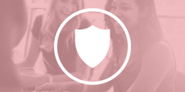 Three women are engaged in conversation, smiling and enjoying each other's company. A shield icon overlays the scene, indicating a theme of safety or protection in a casual setting.