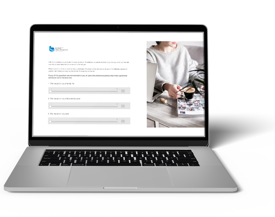 A laptop displays a questionnaire about personal circumstances while a person holds a coffee cup, sitting beside it on a wooden table. A magazine lies open nearby.