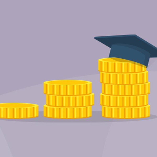 A stack of gold coins increases in height, topped with a graduation cap. The background is a soft gray, enhancing the focus on the coins and cap.