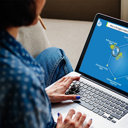 A person sits on a sofa, using a laptop to view a colorful infographic featuring a central graphic and connected elements, possibly related to research or analytics.