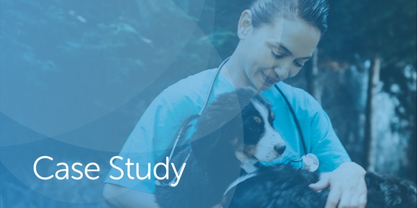 A veterinarian holds a dog closely while smiling gently. The setting appears to be outdoors, surrounded by greenery, suggesting a caring and professional environment. Text reads "Case Study."