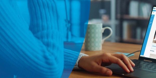 A hand rests on a laptop displaying the BW Risk Portal website. The background features a blurred coffee cup and shelves, suggesting a home office environment.