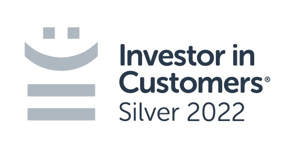 A logo features a smiling icon above the text "Investor in Customers®," with "Silver 2022" below, indicating a recognition achieved in that year. The design is clean and professional.