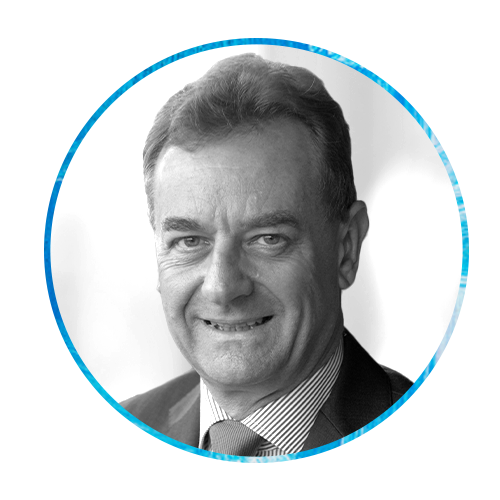 A round portrait of a man smiling, dressed in a suit and tie. The background features an abstract blue and white paint design, contrasting with his formal appearance.